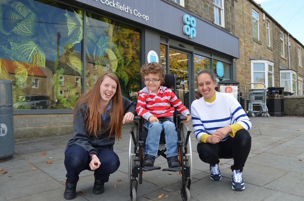 HAPPY TO HELP: Teddy Berriman pictured with his mum, Nicola Short, and Kayleigh Bell who has donated £300 to Team Teddy to help buy specialist equipment that will help the youngster stand and walk