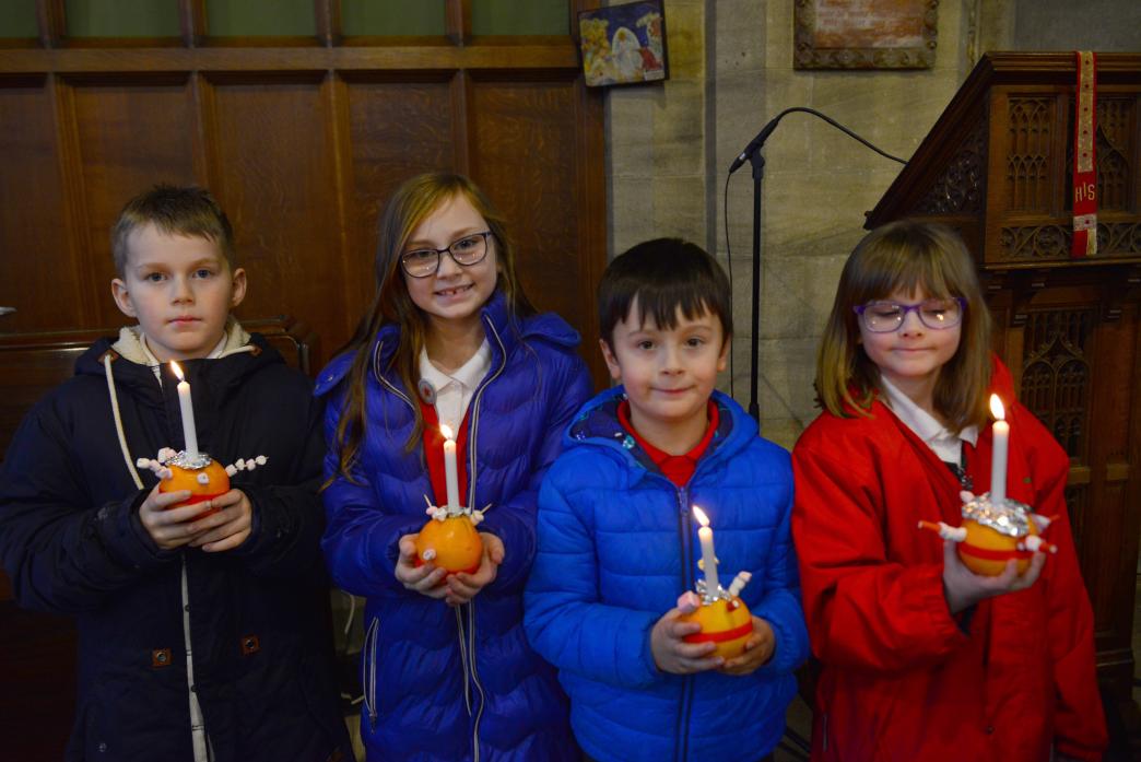 Thomas Ronney, Ava Carline, Harvey Sams and Rosie Blackett with their Christingles