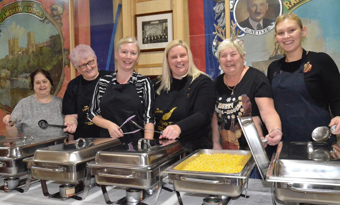 GREAT EFFORT: Caterer Kim Clark (third from left) with volunteers Michelle Harvey, Susan Hale, Clare McGregor from the Angel Trust, Alison Stoker and Claire Burt ready to dish up a festive feast						  TM pics