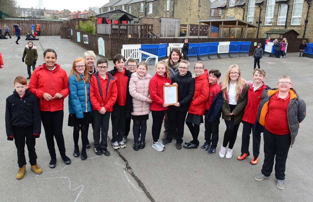 READ ALL ABOUT IT: Cockfield primary headteacher Kathryn Heatherington and teacher Emma Woods with pupils after they heard that their school ranks in the top one per cent for reading in England