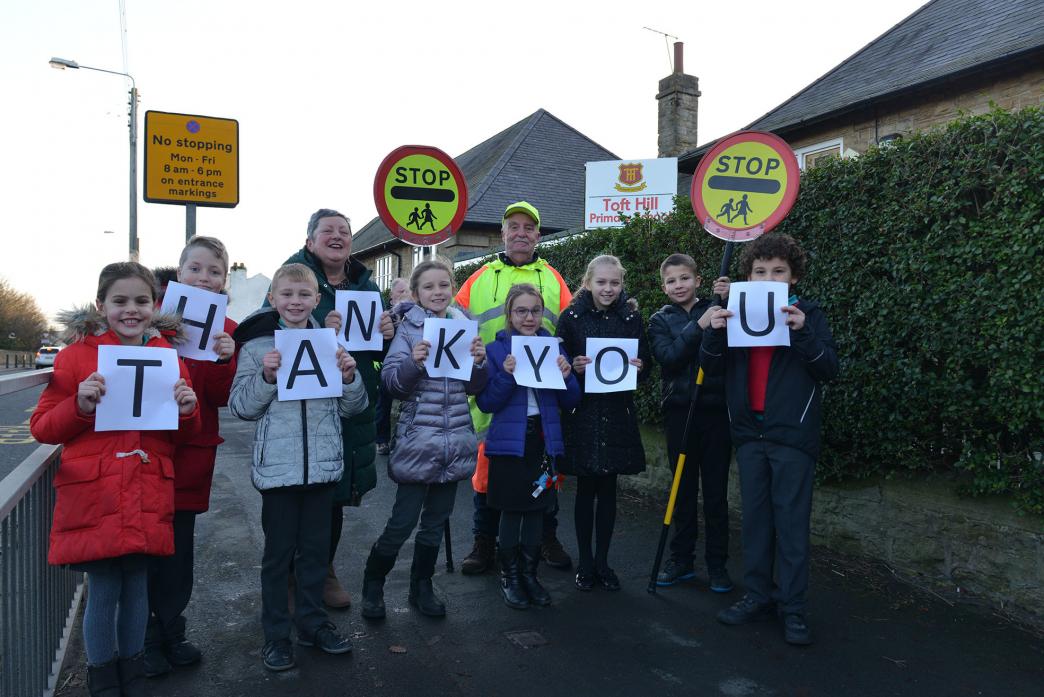PLANS WELCOMED: Headteacher Janice Stobbs, lollipop man Keith Hymer and pupils welcome the announcement that a 20mph speed limit is to be finally introduced in front of Toft Hill Primary School   						   TM pic