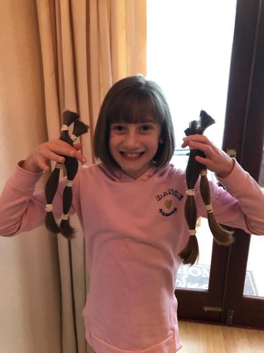 OFF WITH HER HAIR: Emily Luck with the locks she had cut for The Little Princess Trust