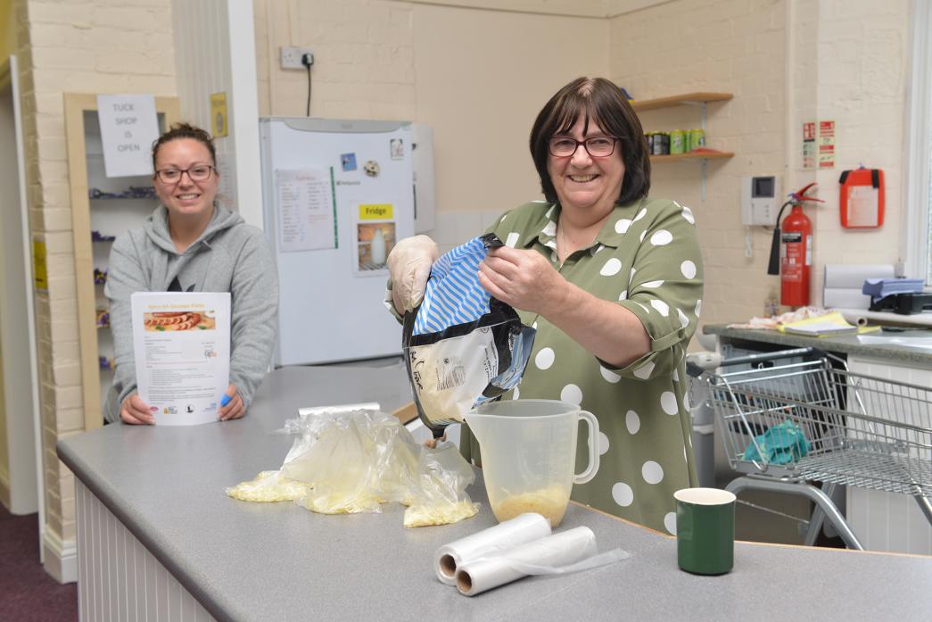 HEALTHY EATING: Jen Smurth-waite measures out ingredients for the latest Cook Your Own Tea delivery while Gina Richardson reviews the latest recipe