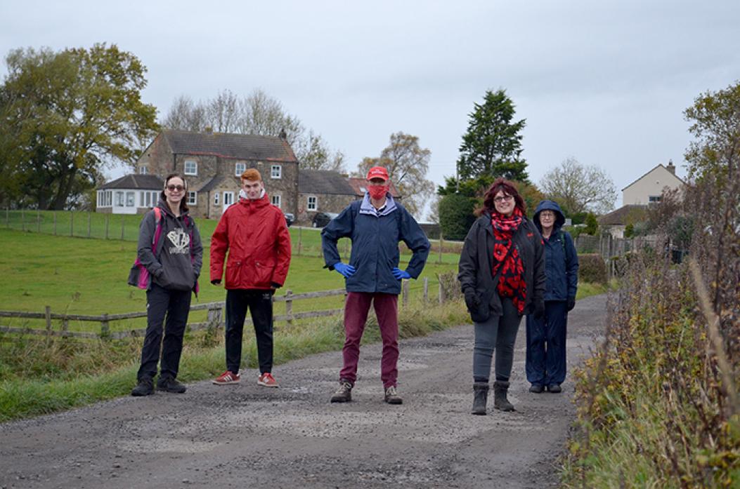 WHERE IT ALL BEGAN: Local historian John Raw, centre, sets out with railway buffs from the start of the Stockton and Darlington line, with East Park Farm in the background