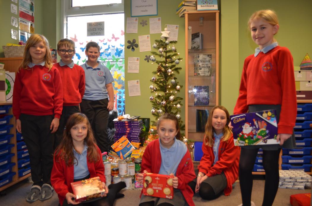 St Mary’s RC School pupil Chloe, front left, came up with the idea for a foodbank advent. She is pictured here with classmates Karnel, Byron, James, Frankie, Chloe and Poppy              TM pic