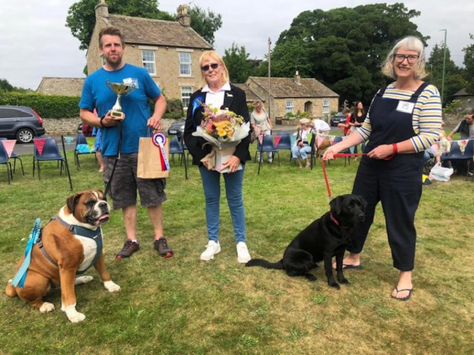 TOP DOGS: Judge Josephine Lee with best in show winner Milo and owner Andrew plus reserve, Brennah with owner Wendy