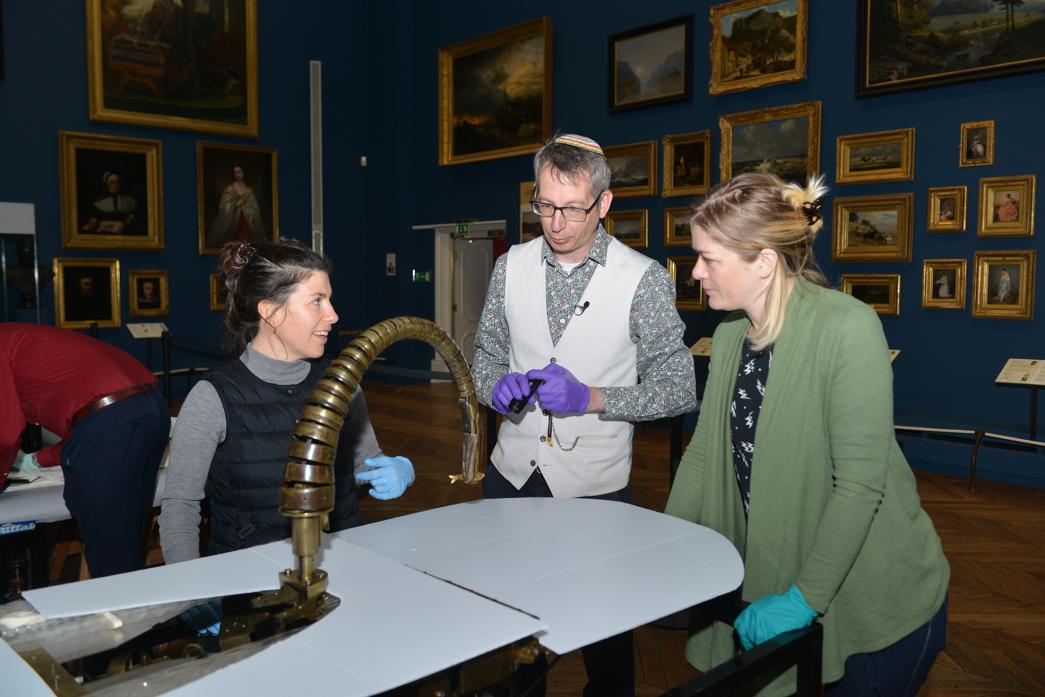 TIMELESS: Conservator Daniella Corda, of the Royal Museums Greenwich, watchmaker Seth Kennedy and curator Anna Rolls, of the Clockmakers Museum, examine the head and neck