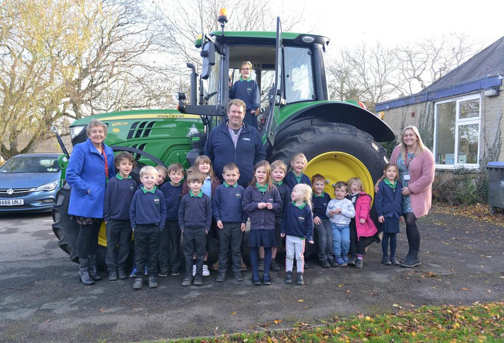 TRACTOR TALES: Farmer William Maughan shows children from Cotherstone Primary School how a tractor works