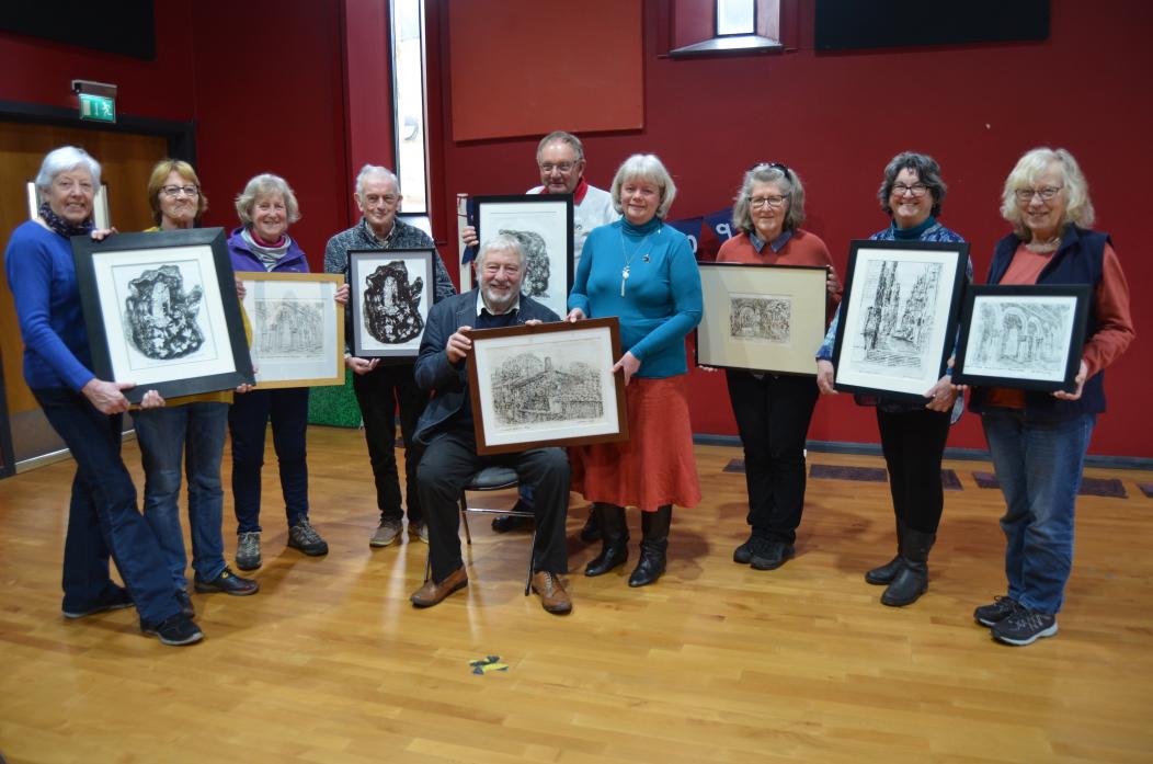 LOOKING FOR IDEAS: Artist Anthony Clark, seated, presents the Making Memories Group with eight engravings which will be sold