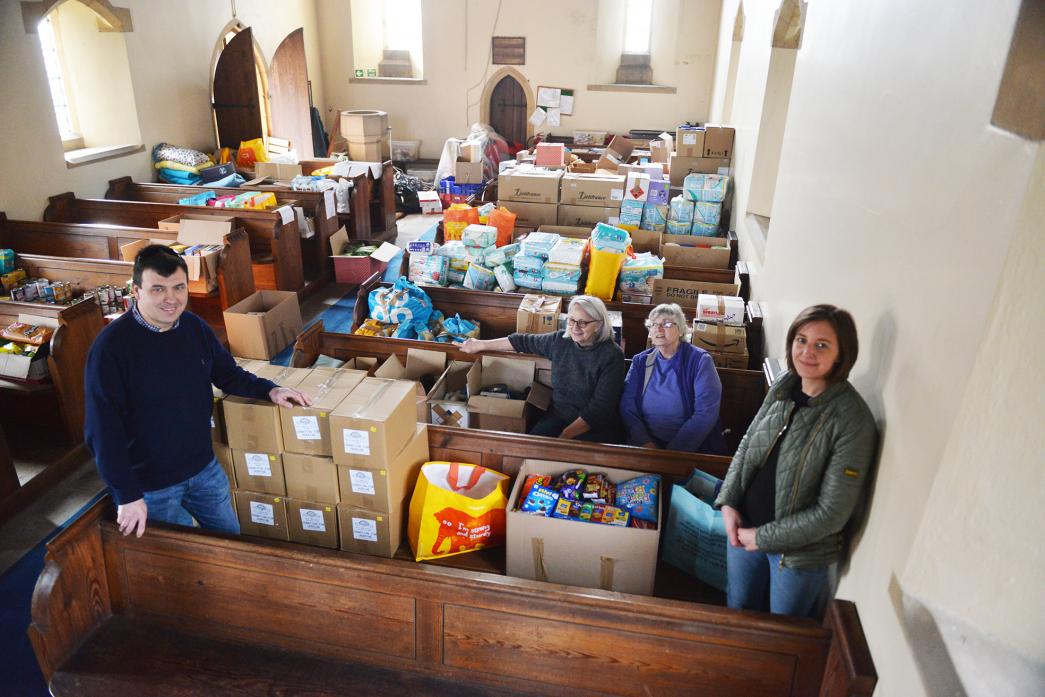 PACKED CHURCH: Mark Rumble, Liz Hodgson, Shirley Chalmers and Lucy Needham with the wealth of items that have been collected through the Piercebridge community appeal for Ukrainian refugees  					     TM pic
