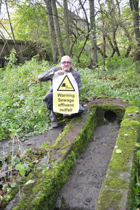 WASTE CONCERNS: Martin Bacon with the signs he aims to put at Deepdale after sewage was leaked into the nearby beck