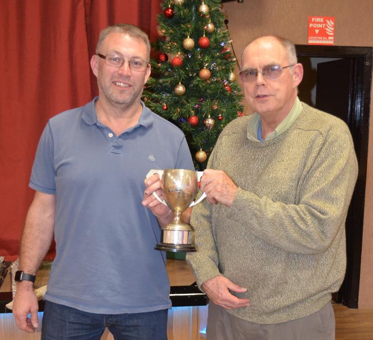 HOOKED ON FISHING: Gareth Hinchcliffe receives the fly fishing trophy from angling club president John Cartwright