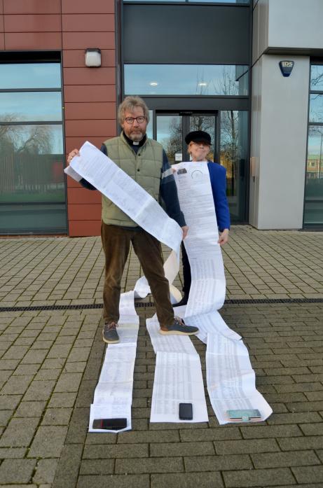 STRENGTH OF FEELING: Revd Canon David Tomlinson and church warden Andrea Clarke unrolled the scroll petition outside the Department of Education in Darlington