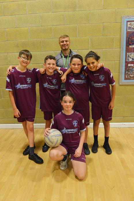 NEW KIT: Coach Charlie Dixon with netball players Lucas, Blake, Michael, Horia and Amelia from Oakley Cross Primary School TM pic