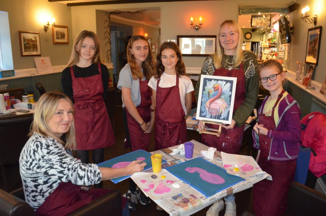 PICTURE PERFECT: Artist Jo Pickering, seated left, with the young artists taking part in her Saturday morning workshop for Turn Barney Pink				              TM pic