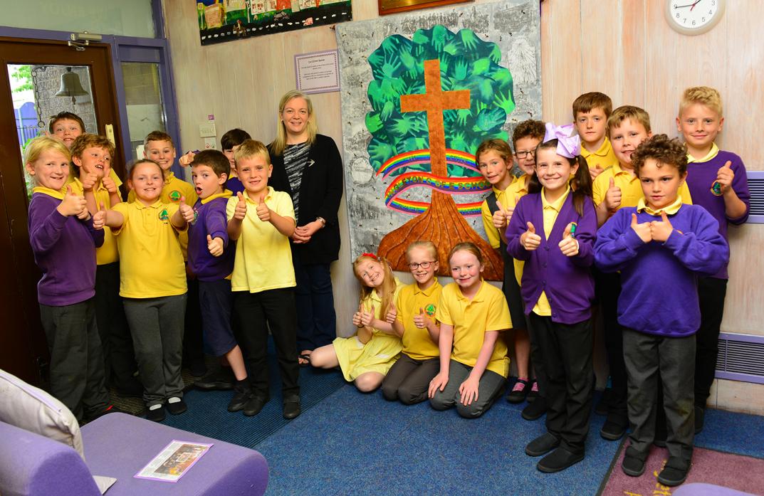 THUMBS UP: Artist Vicky Holbrough with children from Ingleton Primary School who helped produce the banner