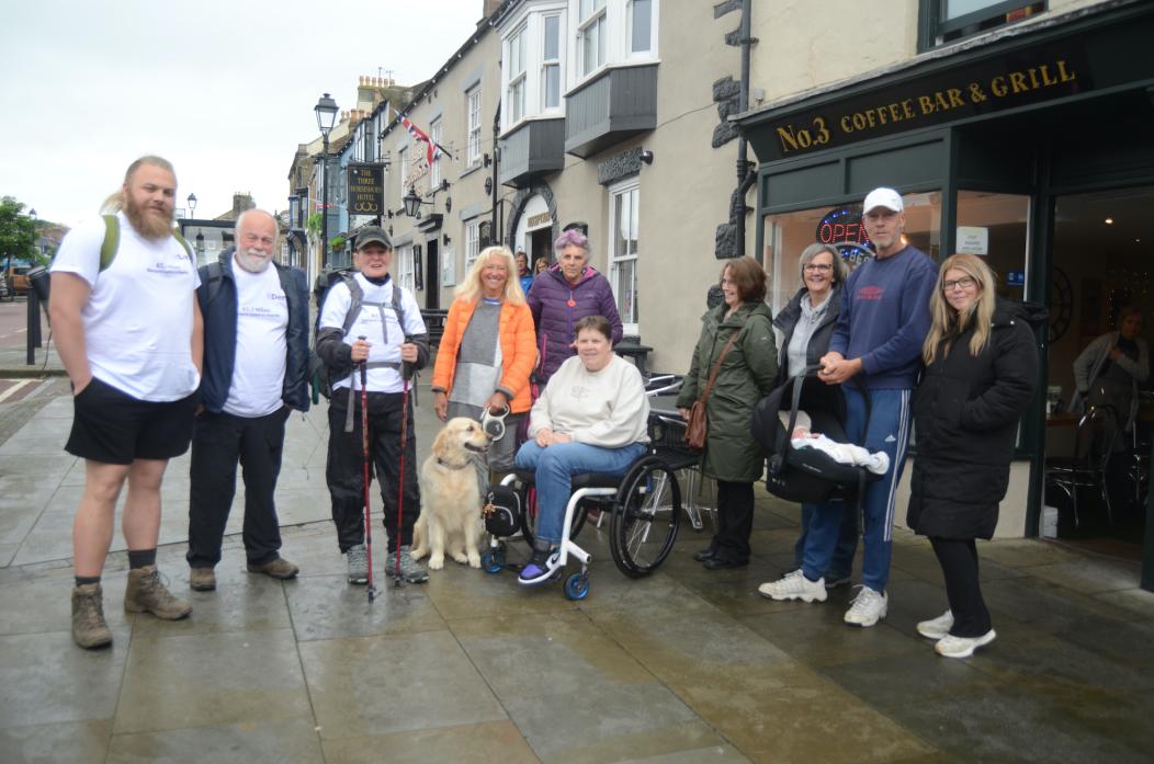 BEST FOOT FORWARD: Suzanne Thomas sets off on a moorland hike to raise funds to purchase an all-terrain wheelchair for friend and volunteer Sue Baillie. Derek and Lewis Baillie, left, accompanied her on the trek  						              TM pic