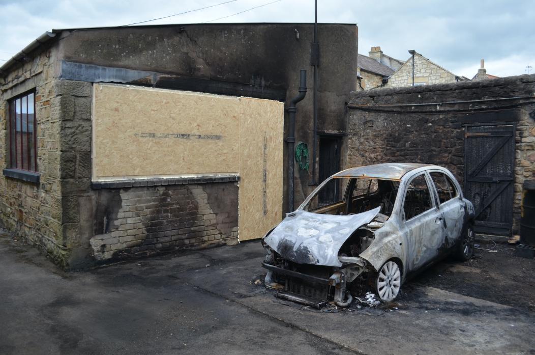 SUSPICIOUS BLAZE: The burnt out car and damaged workshop at Vere Road Garage				    TM pic