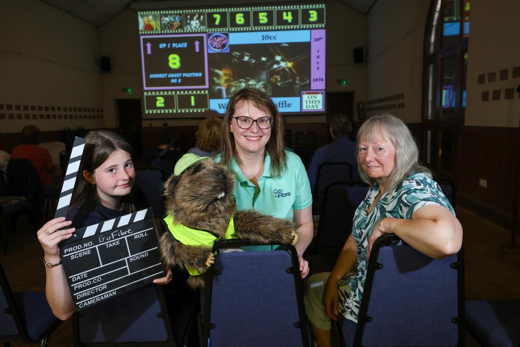 FAST FIBRE: Mickleton Cinema Club regular, Sue Kelly, right, with grand-daughter Ivy Swanston, left and GoFibre’s representative and mascot