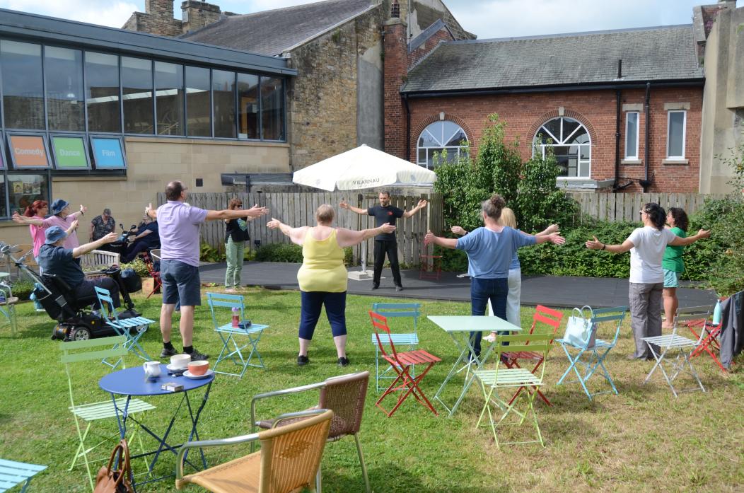 MOVE SLOW: The group enjoy a free taster session of Qigong in The Witham Cafe Garden as part of the summer festival activities