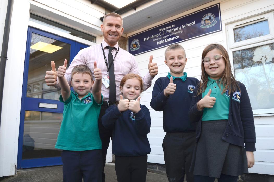 GLAD TO BE BACK: Headteacher Steve Whelerton and pupils give the school repairs the thumbs up