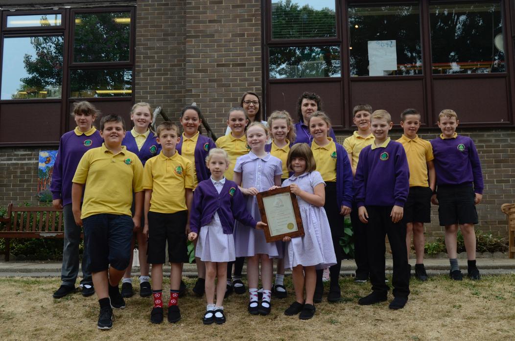 WELL DONE: Chloe Brown and teacher Michelle Brass with members of Ingleton School council showing off their Investing in Children Award