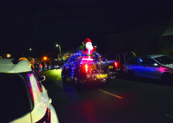 COLOURFUL SPECTACLE: A pick-up and a tractor in all their festive finery take part in the Farmer Christmas parade in the upper Gaunless Valley