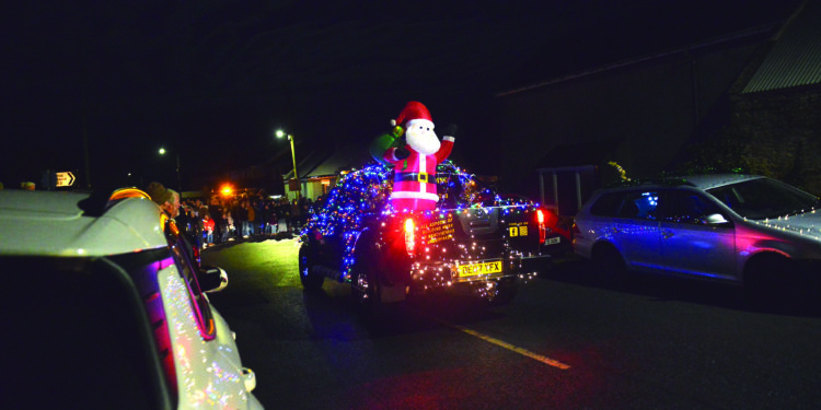 COLOURFUL SPECTACLE: A pick-up and a tractor in all their festive finery take part in the Farmer Christmas parade in the upper Gaunless Valley