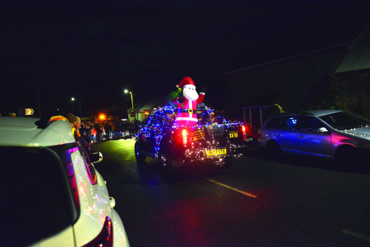 COLOURFUL SPECTACLE: A pick-up and a tractor in all their festive finery take part in the Farmer Christmas parade in the upper Gaunless Valley
