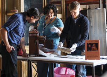 CABINETS OF CURIOSITY: Collection curator Joe Kinsey and learning manager Alia Cruz were using special museum vacs when they carried out cleaning work on a 19th century doll’s bed, left