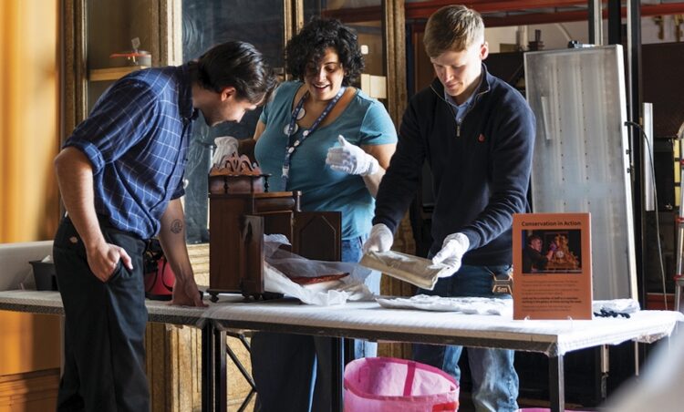CABINETS OF CURIOSITY: Collection curator Joe Kinsey and learning manager Alia Cruz were using special museum vacs when they carried out cleaning work on a 19th century doll’s bed, left
