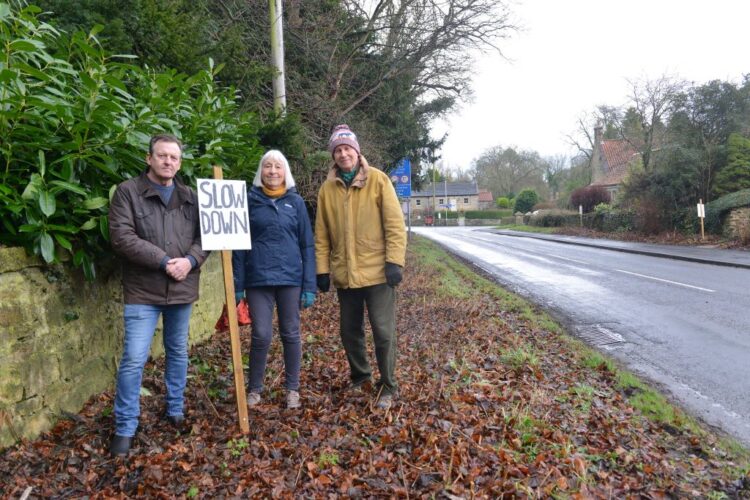 SLOW DOWN: Whorlton Traffic Calming Group members Malcolm Lockyear and Alison Boddy with parish council chairman George Statsny at the T-junction where there has been a spate of collisions and near-misses