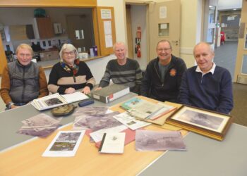 Evenwood and District History Society members pore over aerial photographs from 1964 which will form part of a Then and Now exhibition