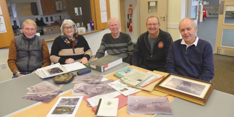 Evenwood and District History Society members pore over aerial photographs from 1964 which will form part of a Then and Now exhibition