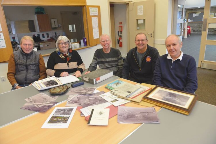 Evenwood and District History Society members pore over aerial photographs from 1964 which will form part of a Then and Now exhibition