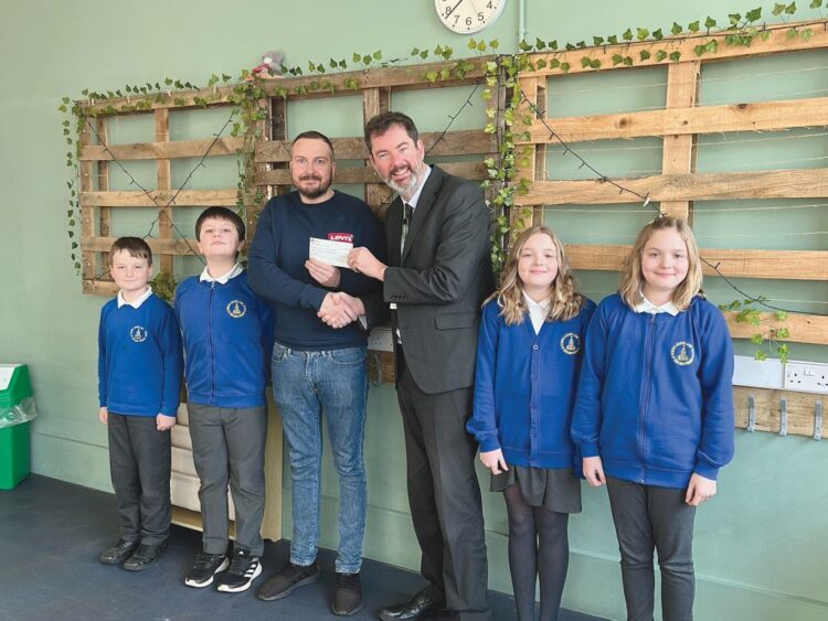 Cllr Adrian Mairs, chairman of Marwood Parish Council, handed over £1,000 to headteacher Rob Goffee and pupils at GReen Lane School towards the cost of developing a nurture hub