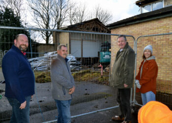 TORN DOWN: Upper Teesdale Community Association members Andy Goodman, Dave Garth, Richard Bell and Grace Crawford look on as contractors make quick work of the demolition of Middleton’s village hall