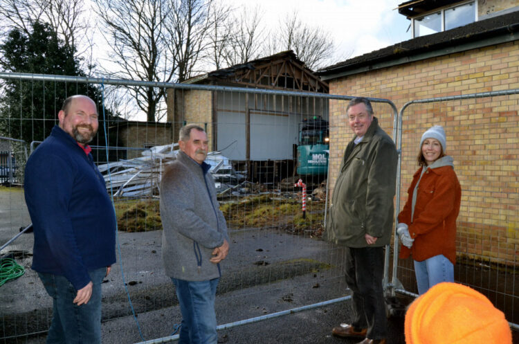 TORN DOWN: Upper Teesdale Community Association members Andy Goodman, Dave Garth, Richard Bell and Grace Crawford look on as contractors make quick work of the demolition of Middleton’s village hall