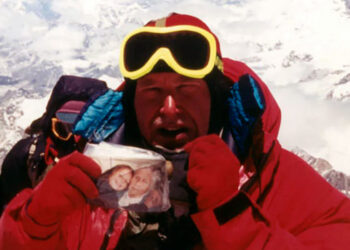 Alan Hinkes with a photograph of his daughter Fiona and grandmother on the summit of Everest