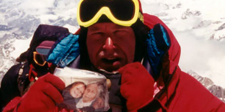 Alan Hinkes with a photograph of his daughter Fiona and grandmother on the summit of Everest