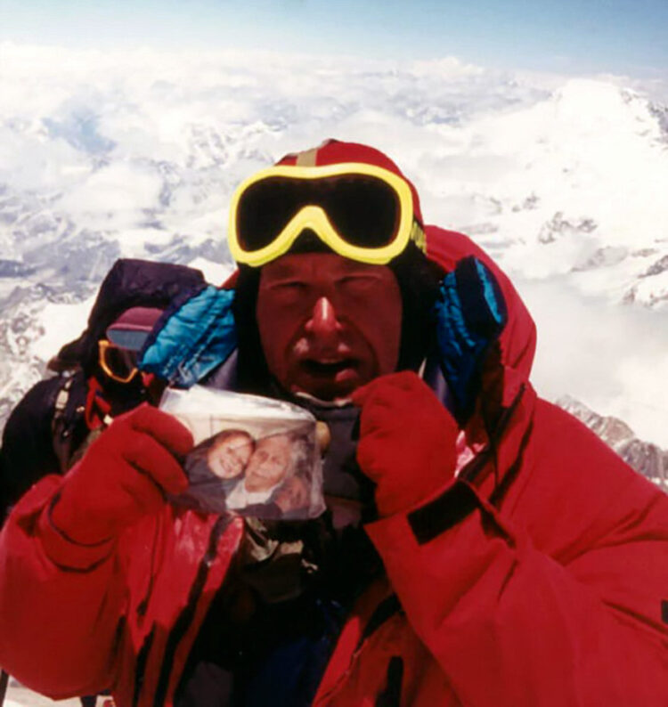 Alan Hinkes with a photograph of his daughter Fiona and grandmother on the summit of Everest