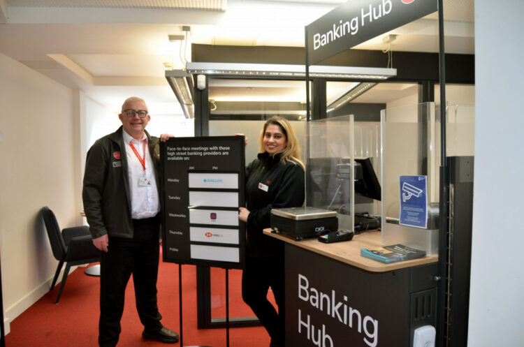 OPEN FOR BUSINESS: The temporary banking hub is now open. Pictured are Post Office on-site trainer Keith Angus-Wall with banking hub operator Nikki Walia-France