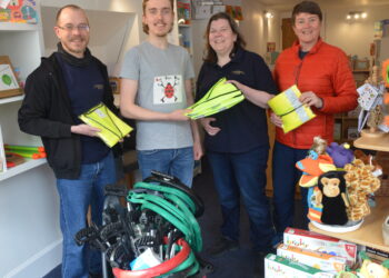 CLEANING UP: Josh Jenkins and Pauline Connelly look on as George O’Brien hands over the litter-picking equipment to Laura Drew