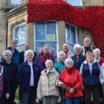 Poppy wave flows down town council building