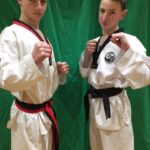 Teenagers celebrate black belt success