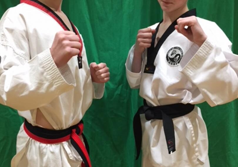 Teenagers celebrate black belt success