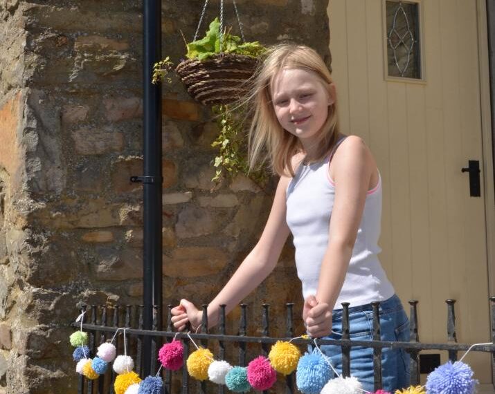 Grace produces pom-poms for charity