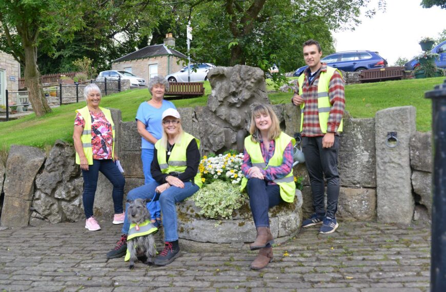 In bloom group back at the job of brightening up village