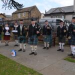 Pipe band busks for instrument funds