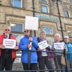 Protesters ‘mourn’ loss of last bank branch